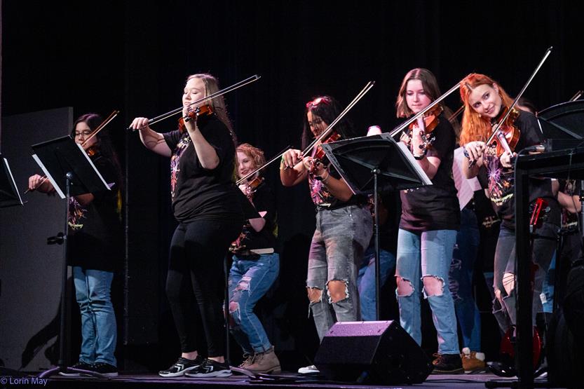 Orchestra students perform onstage